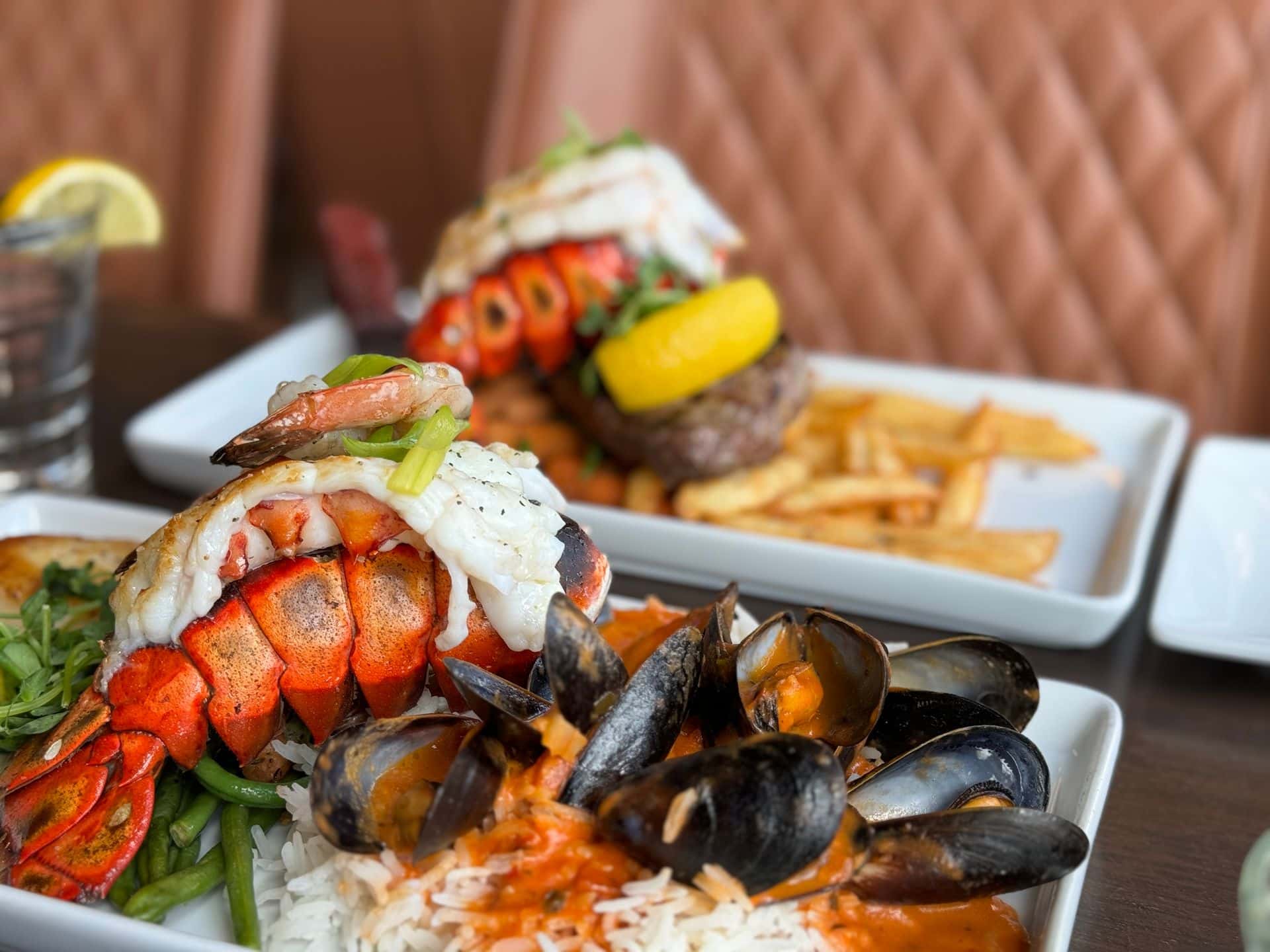 Two heaping plates of seafood cooked to perfection at Copper Blues Bar & Grill in the Village