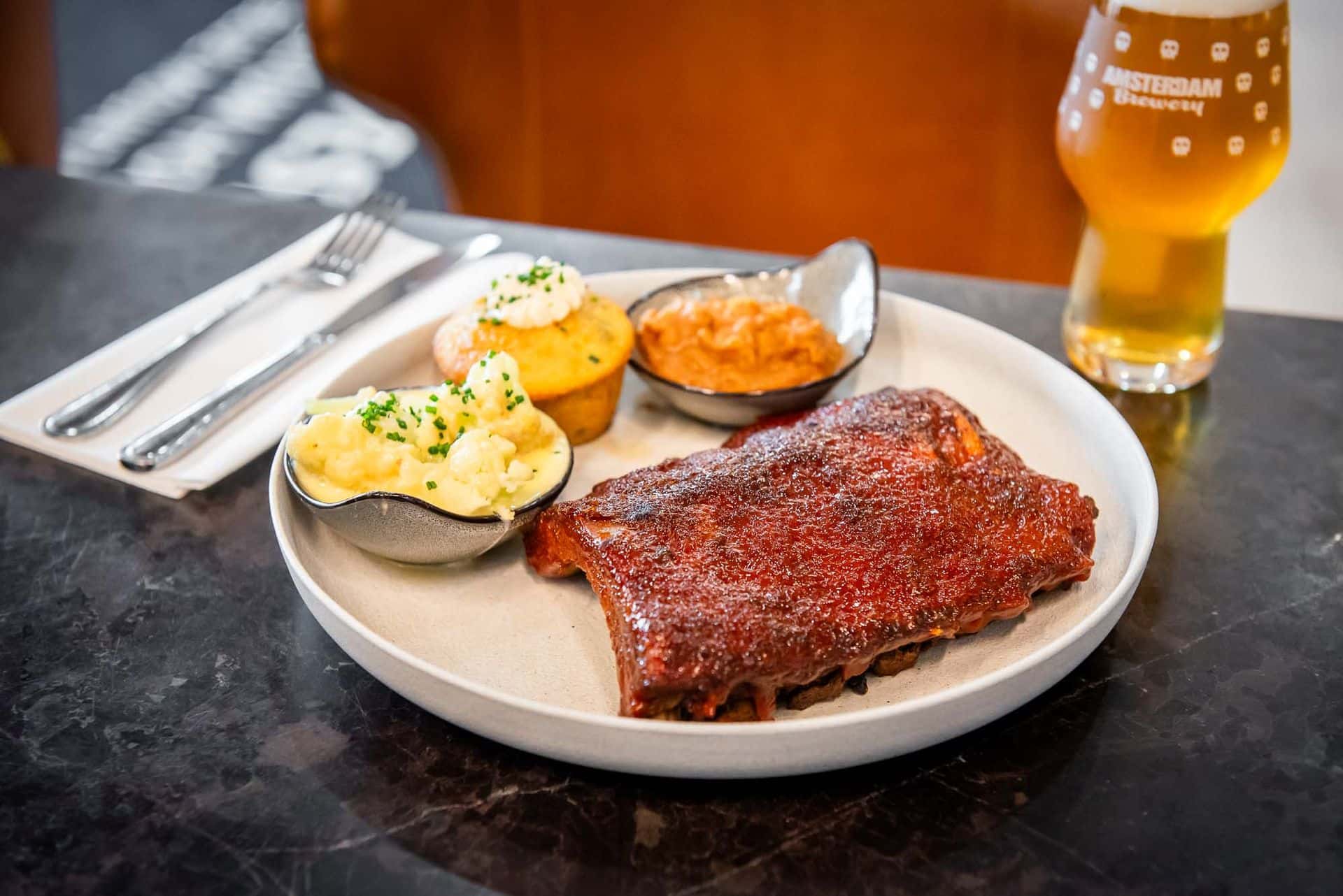 Plated baby back ribs, cornbread and mashed potato sides, served at O&B in the Westin Hotel.