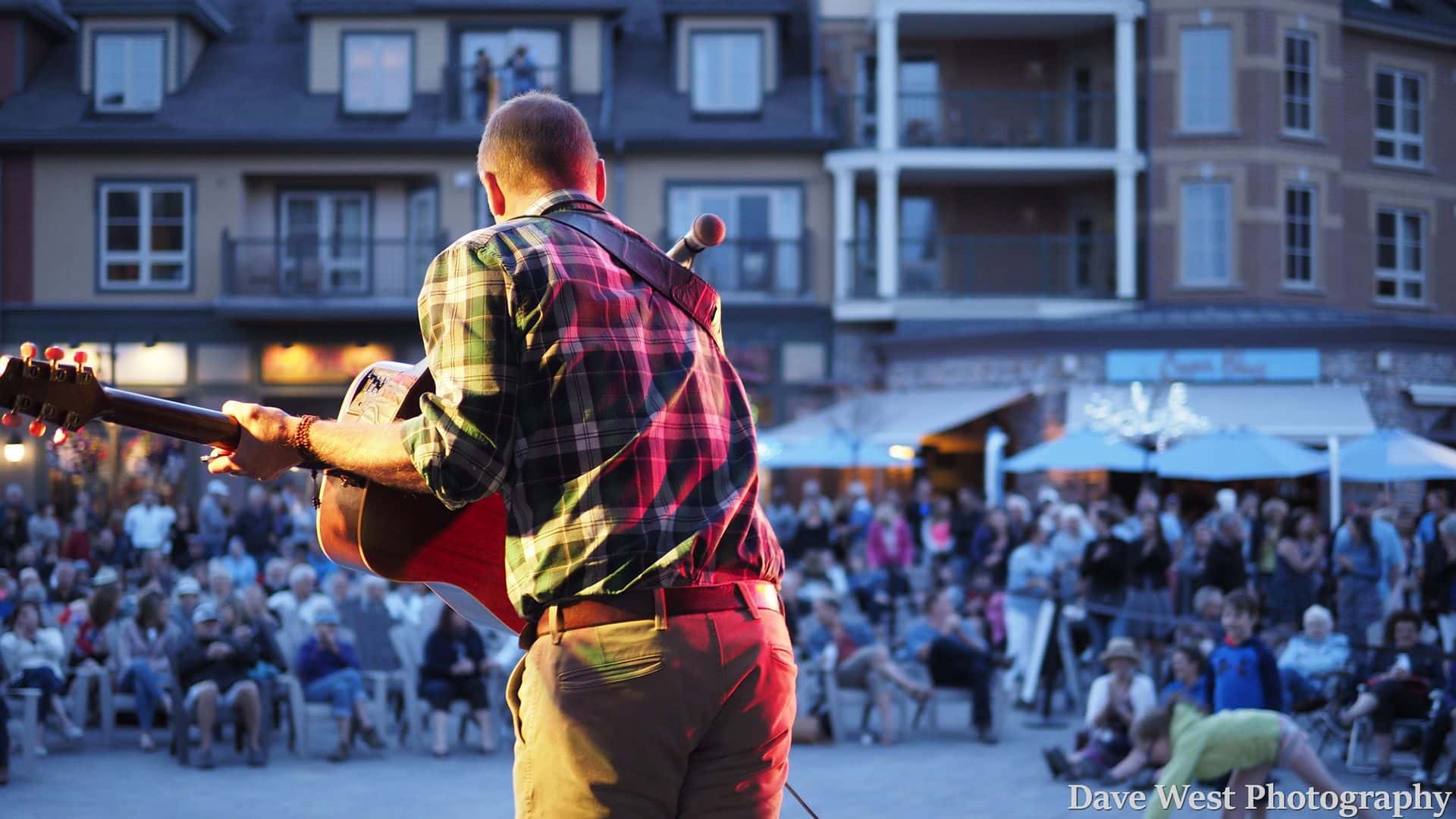 Solo acoustic artist performing live at on the Subaru Stage for Peak to Shore in the Village.