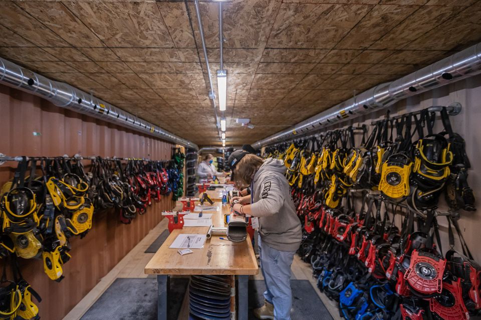 Staff installing ski bindings at the Blue Mountain Resort rental and repair shop.