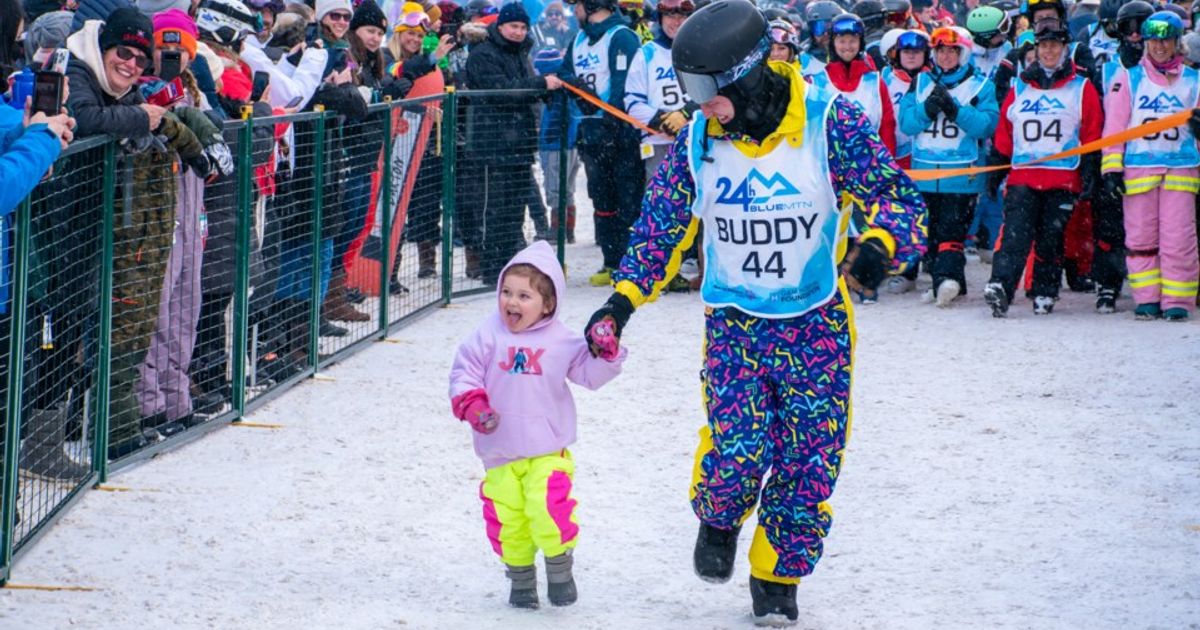 Child running with father at 24 Hours at Blue event.