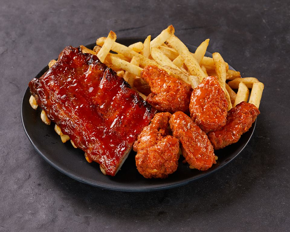 A plate of wings, half-rack of ribs, and fries from Wild Wing Restaurant.
