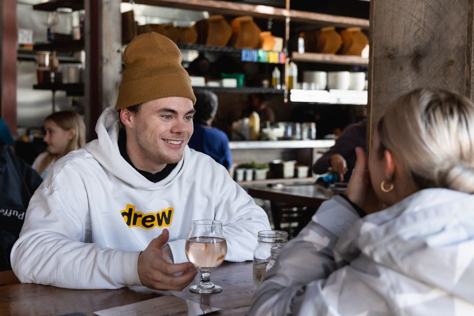 Couple enjoying Après Ski beers at Northwinds Brewery during March Break at Blue.