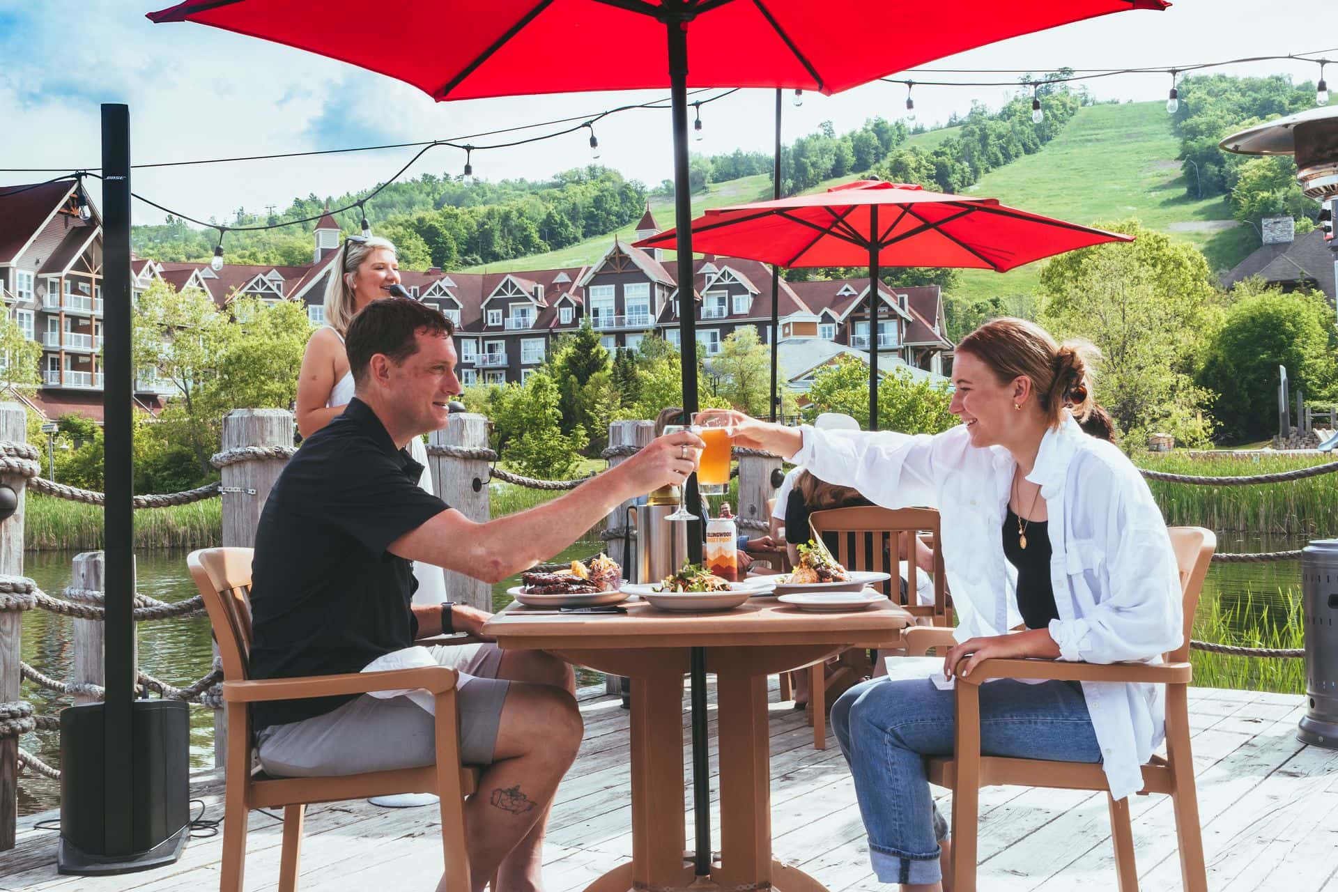 A father and daughter cheers on the Kaytoo Patio.