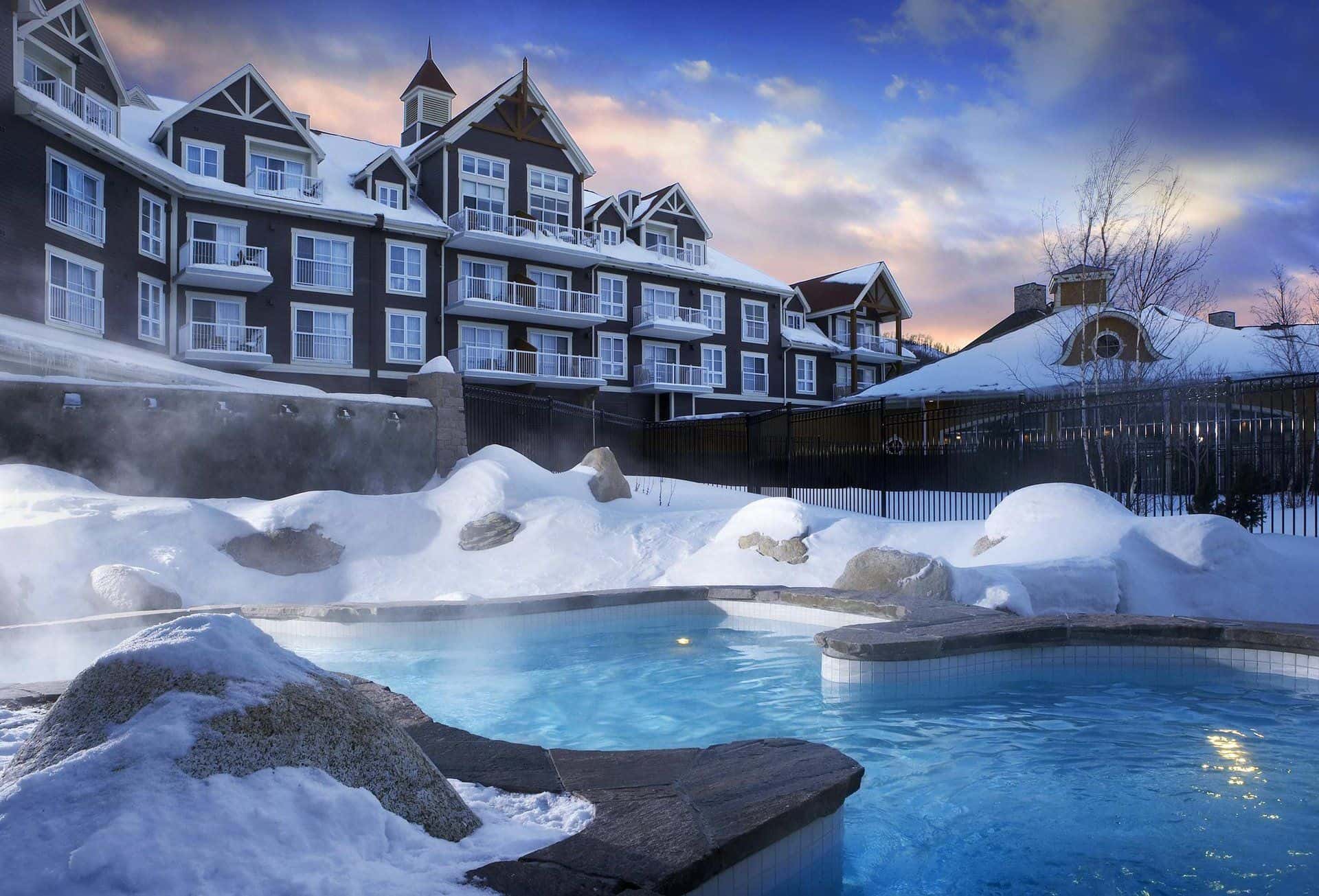Exterior image of the heated outdoor pools and hot tubs during winter at the Westin Trillium House