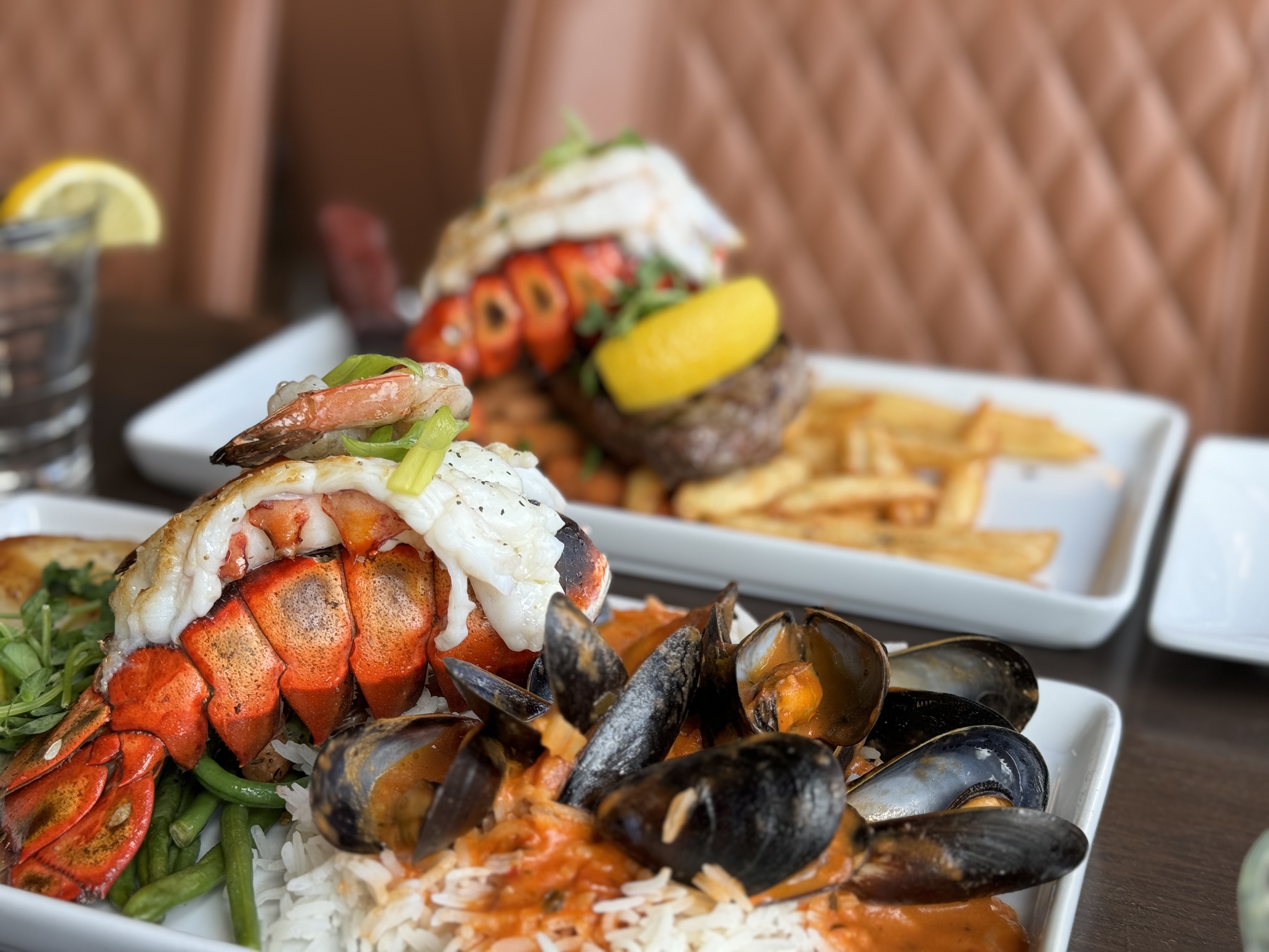 Two heaping plates of seafood cooked to perfection at Copper Blues Bar & Grill in the Village