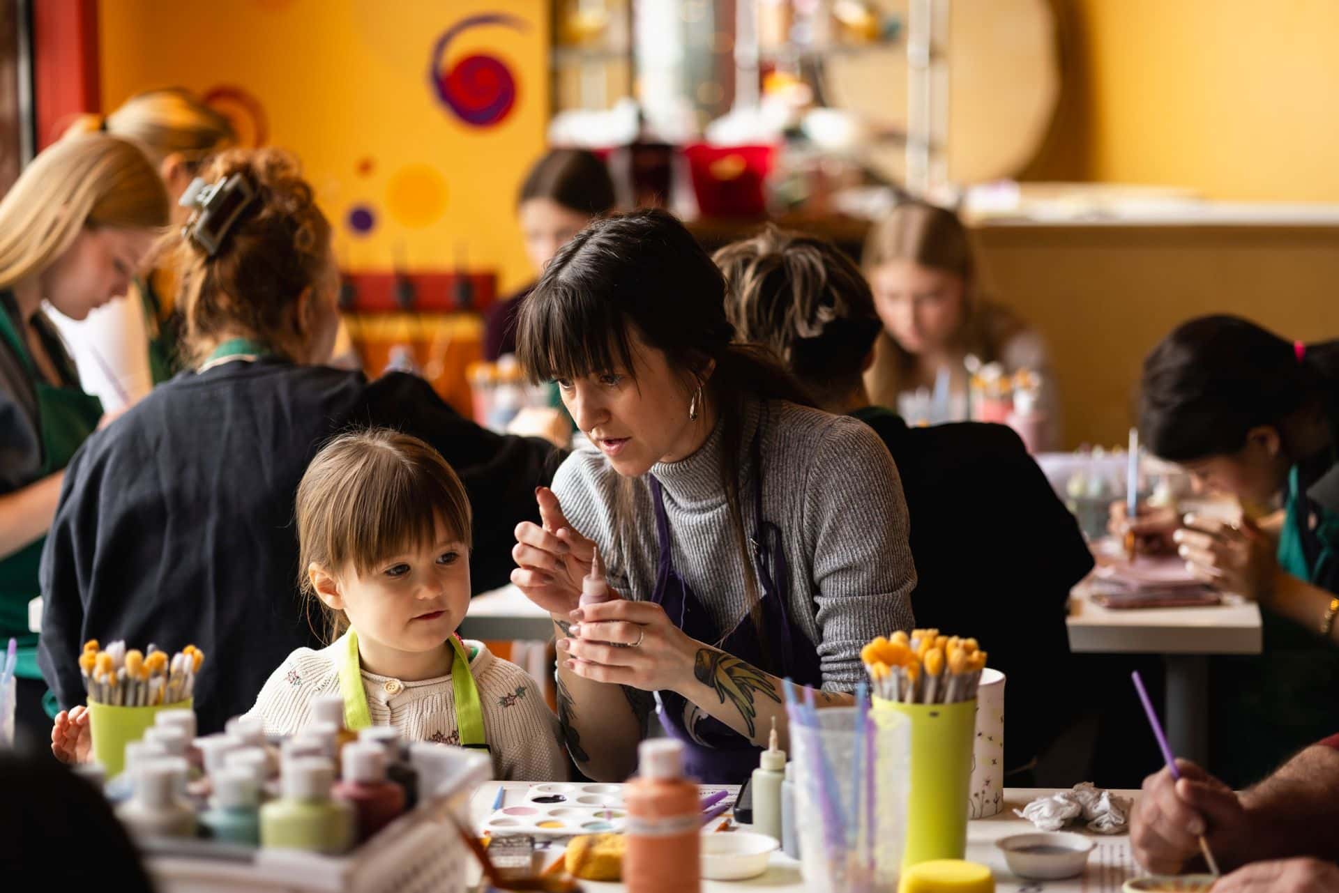 A mom and daughter work together to paint their own pottery on a chilly March Break afternoon at Crock-a-Doodle studio in Blue Mountain Village.