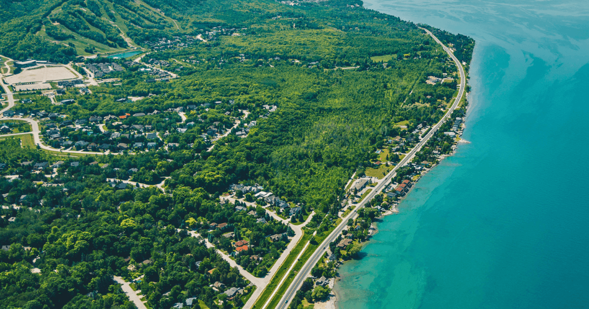 A beautiful aerial shot of The Town of Blue Mountains, showcasing the elevations of the escarpment and the Georgian Bay shores.
