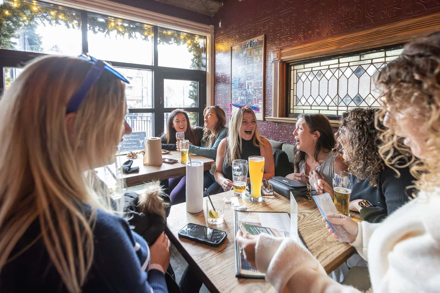 Large group of girls crying laughing over cocktails at MJ Byrne's Irish Pub