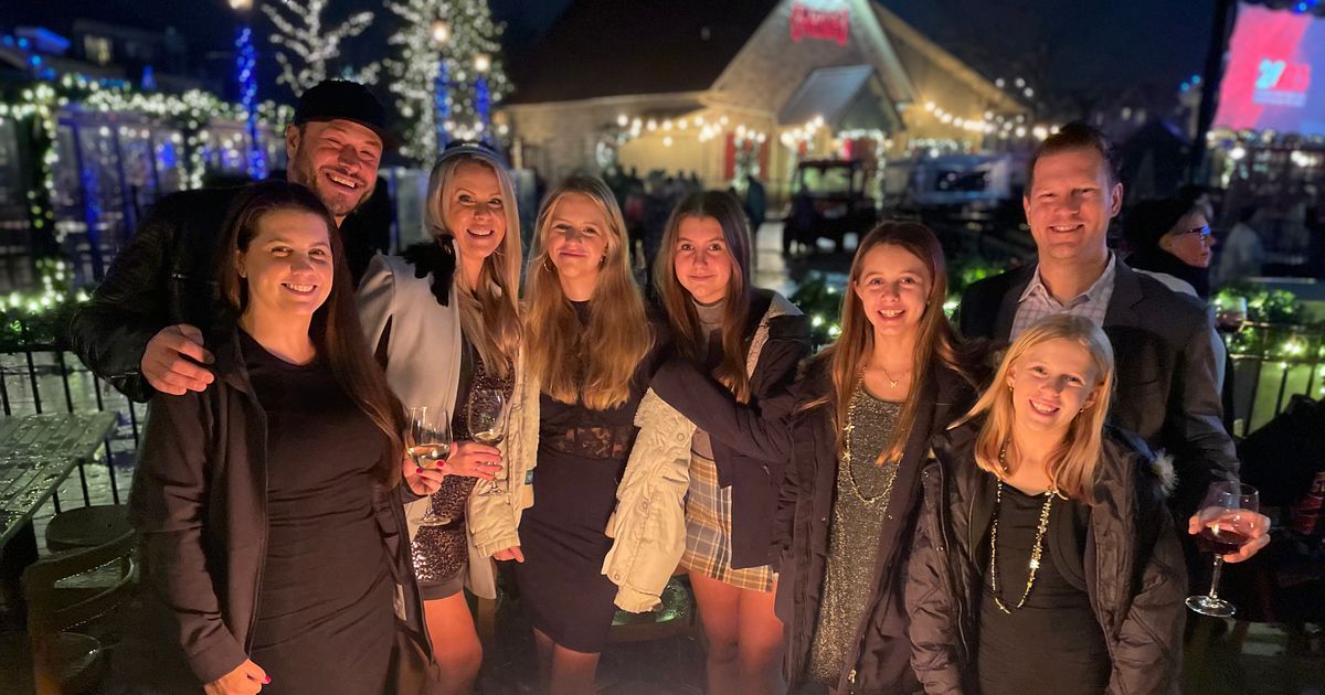 Large family group gathered around the firepits on the Copper Blues patio during New Year's Eve in the Village.