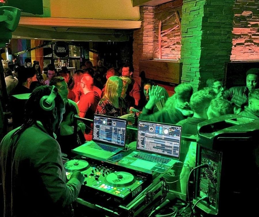 DJ KAOS spinning high-energy beats for a full dancefloor at Kaytoo Restaurant & Bar.