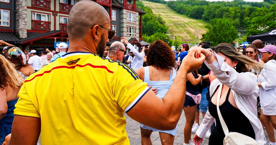 Closeup shot of a couple dancing amongst the crowd during TD Salsa at Blue
