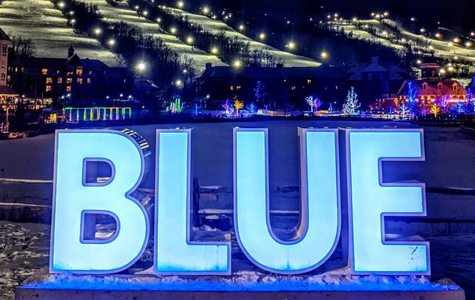 The words Blue lite up in lights and the background of the mountain wil lights