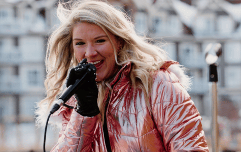 Young women in pink ski suit singing